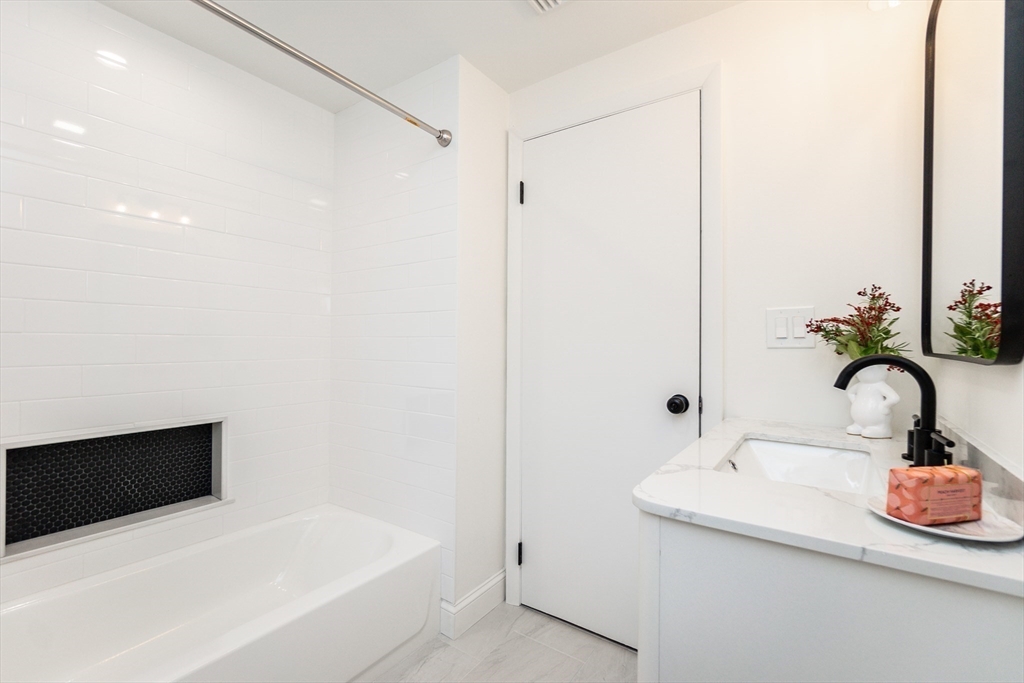 72 Outlook Road Wakefield, MA 01880 - Photo 25 of 42 a bathroom with a sink and a mirror