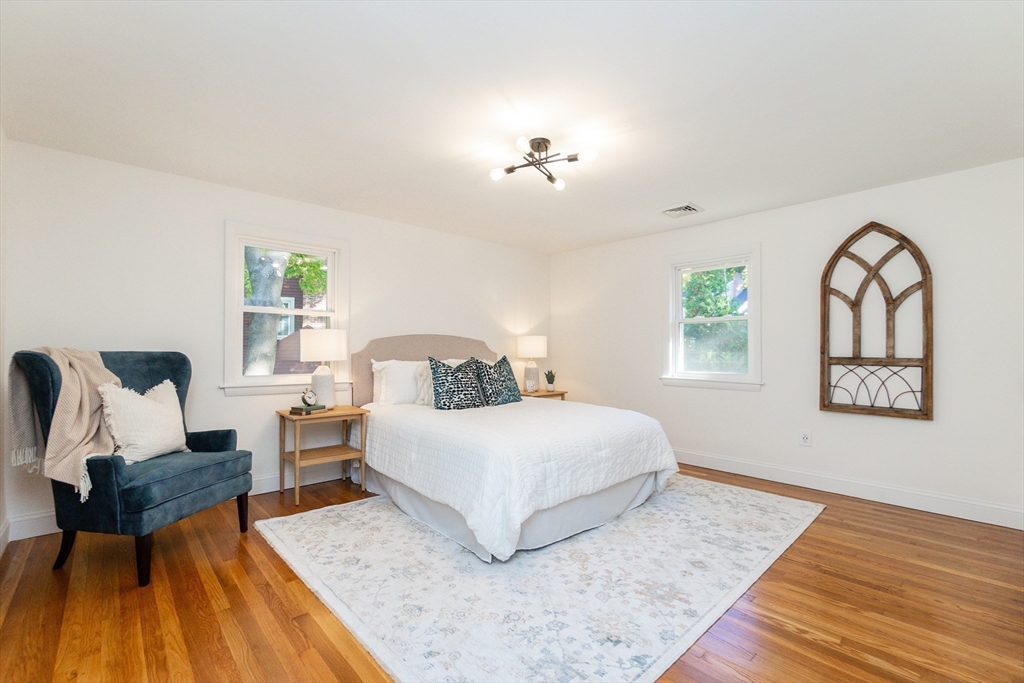 72 Outlook Road Wakefield, MA 01880 - Photo 26 of 42 a spacious bedroom with a bed a couch and a dresser next to a window