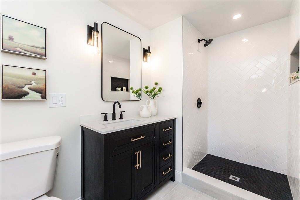 72 Outlook Road Wakefield, MA 01880 - Photo 27 of 42 a bathroom with a sink a toilet a mirror and shower