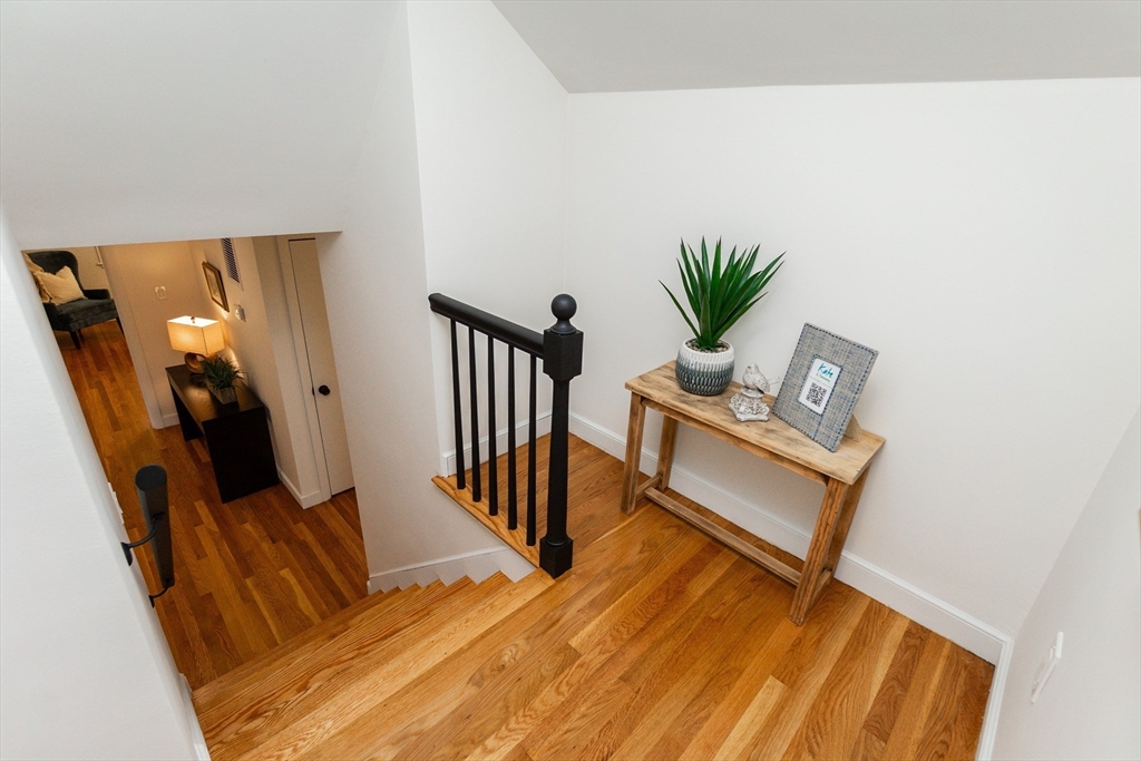 72 Outlook Road Wakefield, MA 01880 - Photo 29 of 42 a view of a hallway with wooden floor and a potted plant