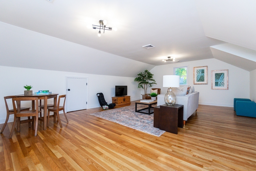 72 Outlook Road Wakefield, MA 01880 - Photo 30 of 42 a living room with furniture and a wooden floor