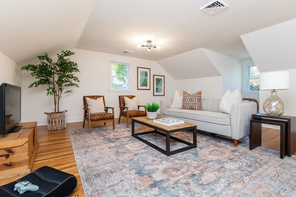 72 Outlook Road Wakefield, MA 01880 - Photo 31 of 42 a living room with furniture and a potted plant