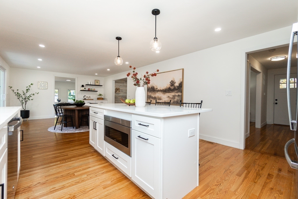 72 Outlook Road Wakefield, MA 01880 - Photo 4 of 42 a kitchen with stainless steel appliances kitchen island granite countertop a stove a sink and a wooden floors