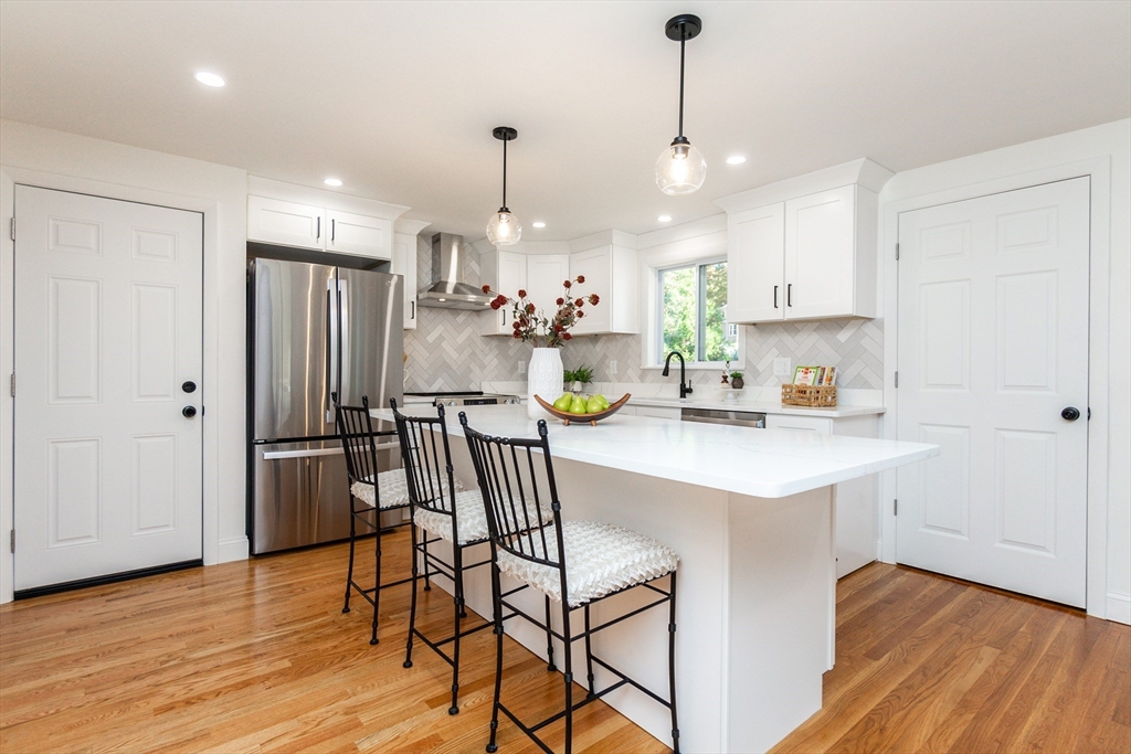 72 Outlook Road Wakefield, MA 01880 - Photo 5 of 42 a kitchen with refrigerator and white cabinets
