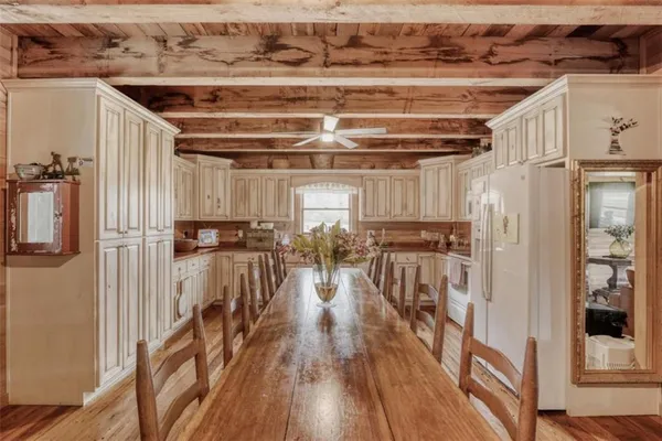 a view of a room with lots of wooden furniture