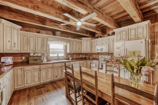 a kitchen with sink table and chairs