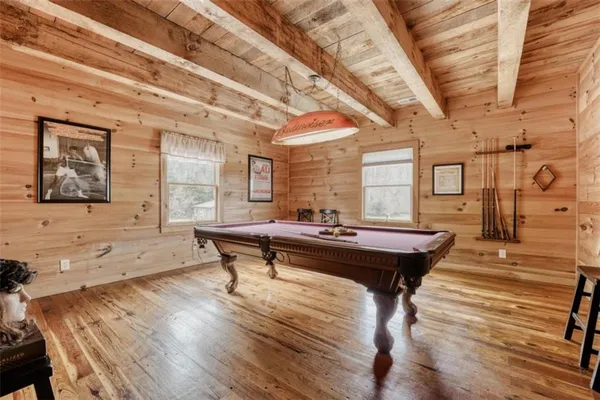 a living room with a table wooden floor and furniture