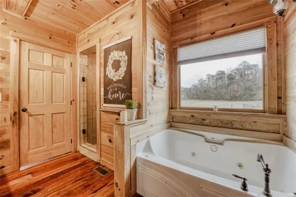 a bathroom with a bathtub and shower