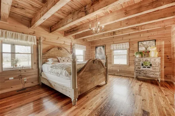a view of a bedroom with wooden floor