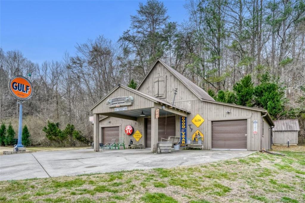 226 Vinson Mountain Road Rockmart, GA 30153 - Photo 3 of 35 a view of a white house with large windows and a small yard