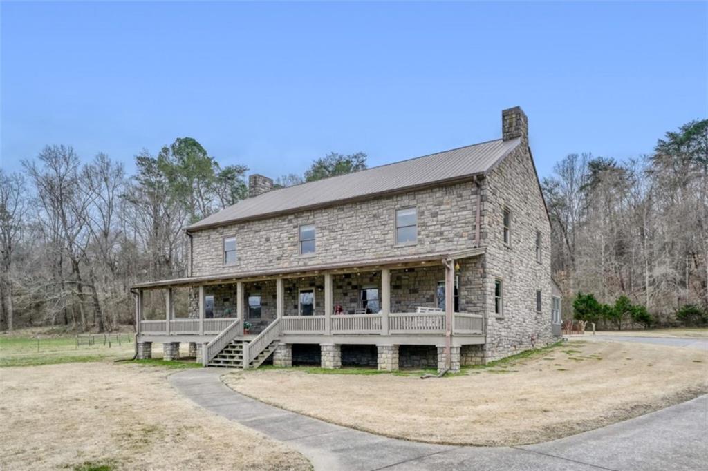 226 Vinson Mountain Road Rockmart, GA 30153 - Photo 6 of 35 a front view of a house with garden