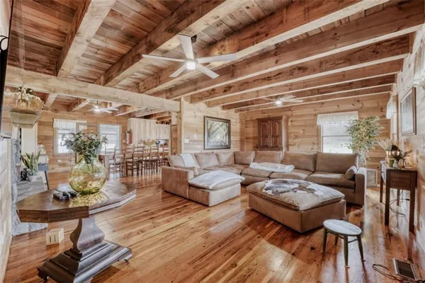 a living room with furniture and a wooden floor
