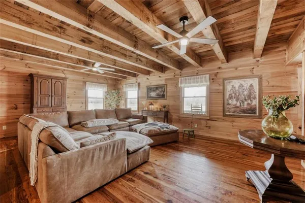 a living room with furniture and wooden floor
