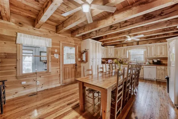 a dining room with furniture and wooden floor