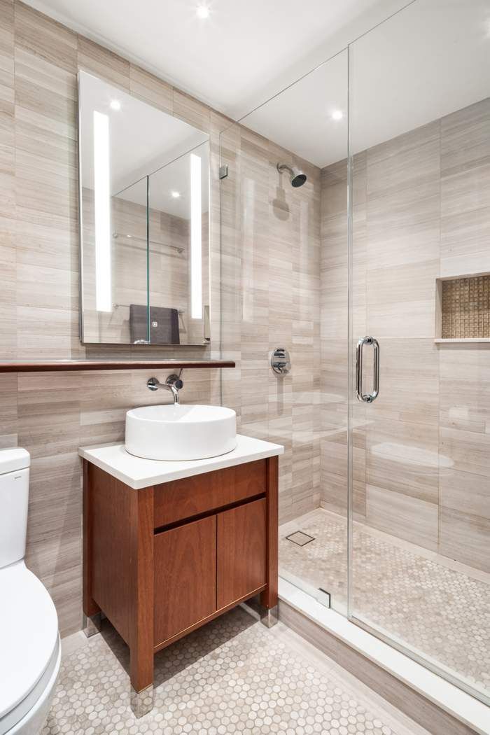 333 West 57th Street, Unit 3CD Manhattan, NY 10019 - Photo 11 of 24 a bathroom with a sink toilet and shower
