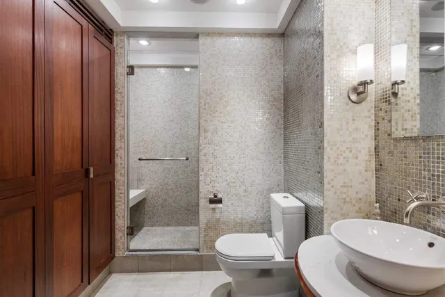 a bathroom with a sink toilet and shower