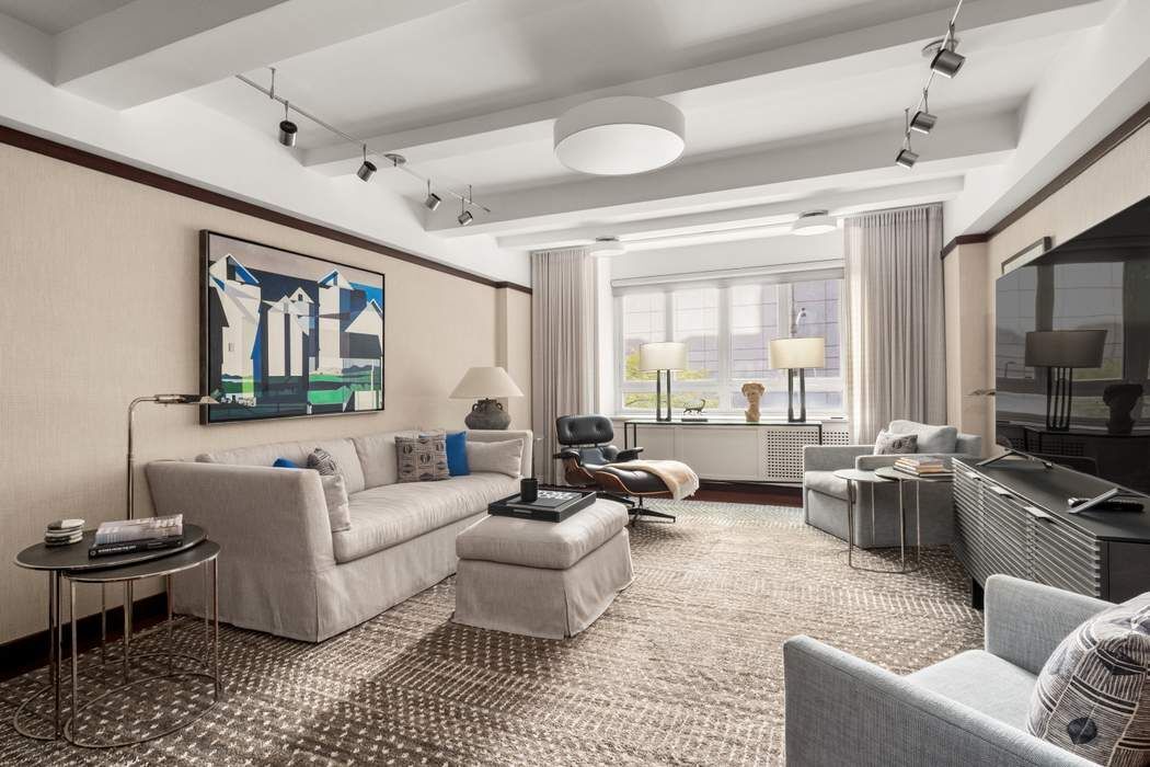 333 West 57th Street, Unit 3CD Manhattan, NY 10019 - Photo 2 of 24 a living room with furniture and a large window