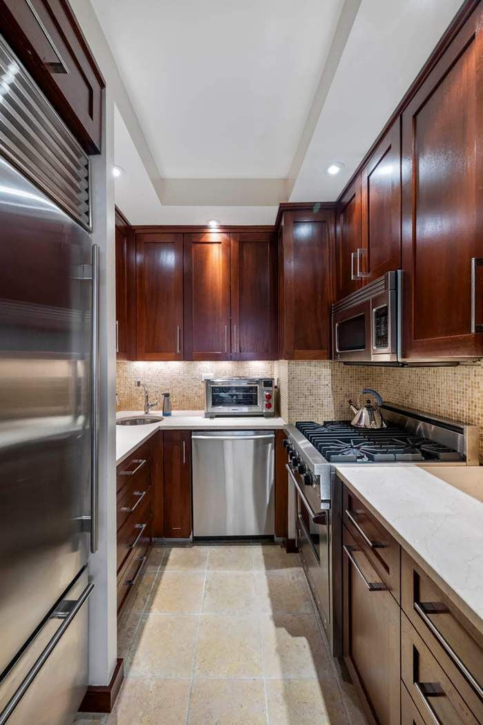 333 West 57th Street, Unit 3CD Manhattan, NY 10019 - Photo 5 of 24 a kitchen with stainless steel appliances granite countertop a sink and stove top oven