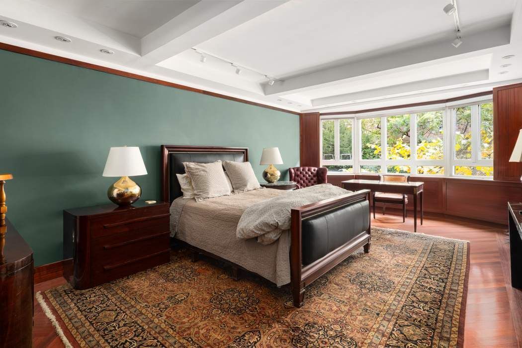 333 West 57th Street, Unit 3CD Manhattan, NY 10019 - Photo 6 of 24 a bedroom with a bed and wooden floor