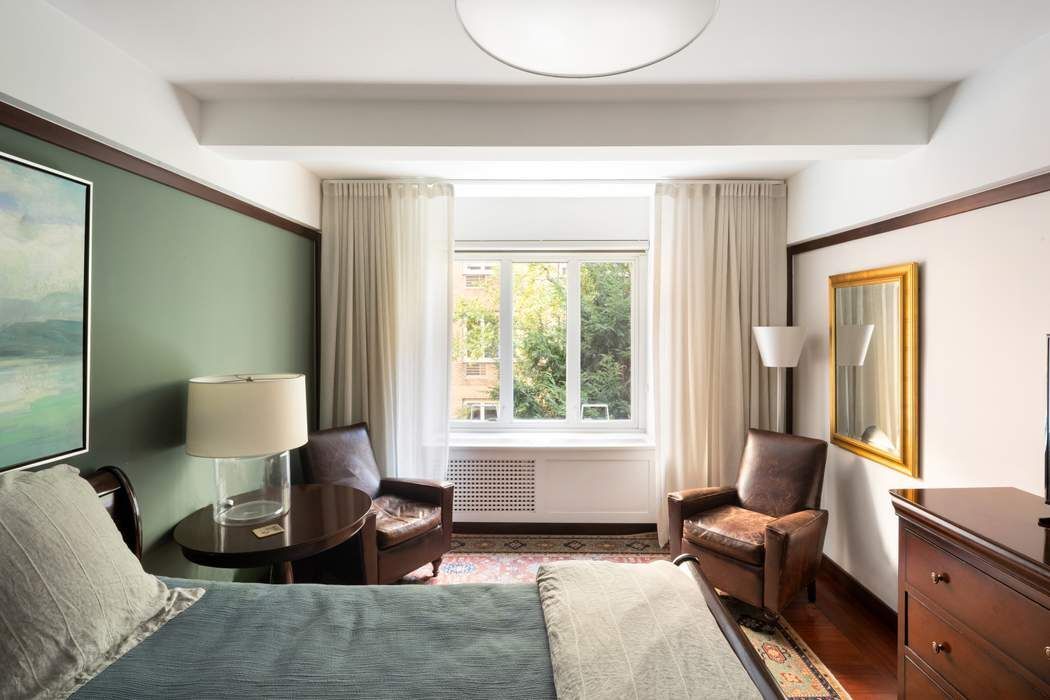 333 West 57th Street, Unit 3CD Manhattan, NY 10019 - Photo 9 of 24 a living room with furniture and a large window