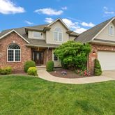 a front view of a house with a yard and porch