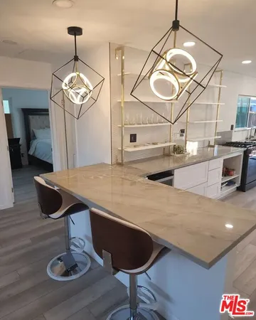 a kitchen with a table and chandelier