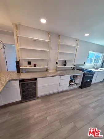 a large kitchen with stainless steel appliances kitchen island granite countertop a large stove a sink dishwasher and a refrigerator