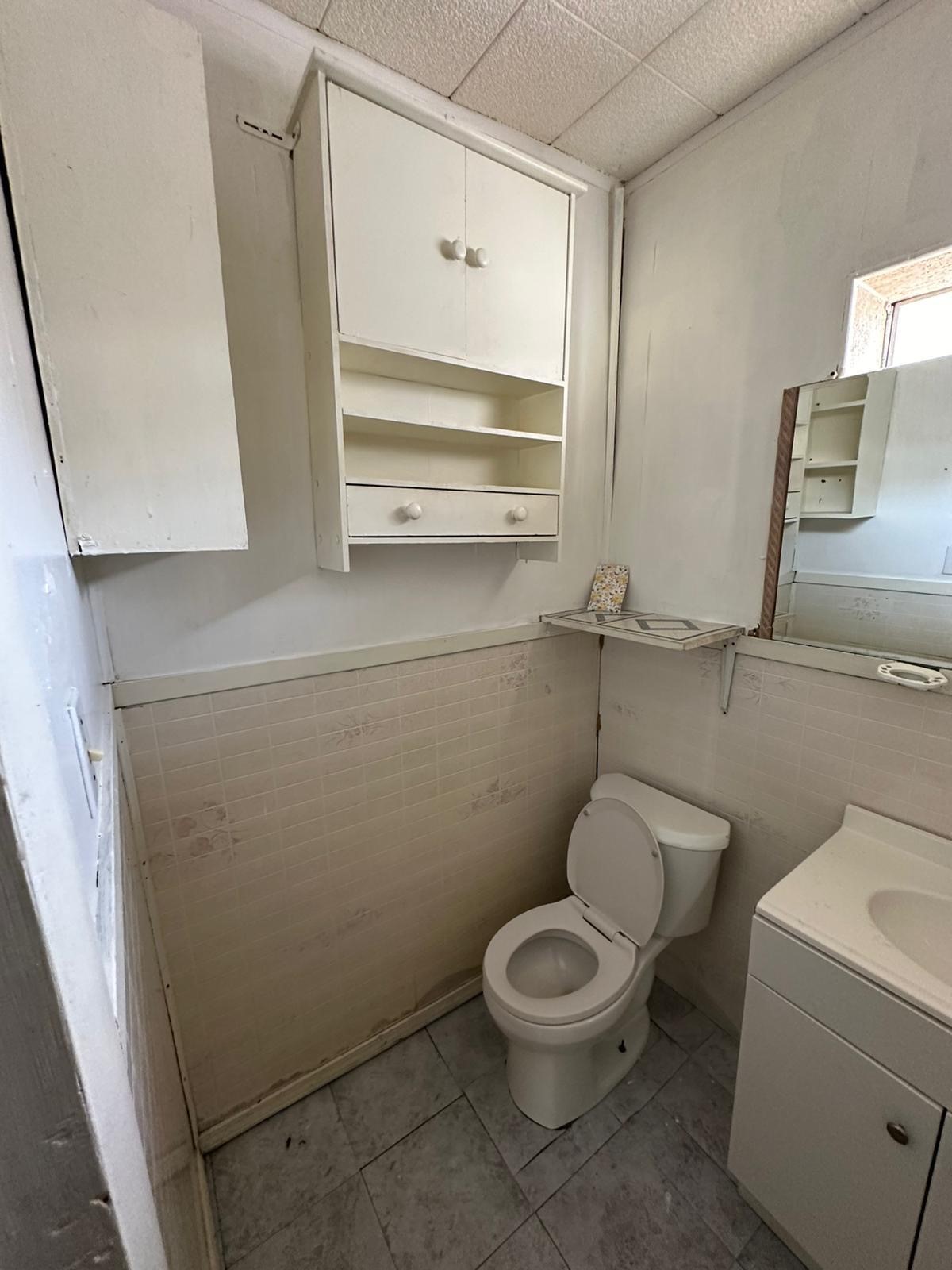 6818 Stearns Street Houston, TX 77021 - Photo 16 of 18 a bathroom with a toilet and a sink
