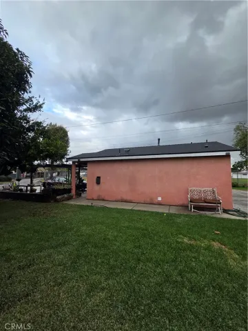 a front view of a house with a garden and yard