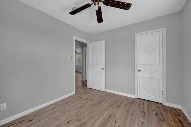 a view of a room with wooden floor and windows