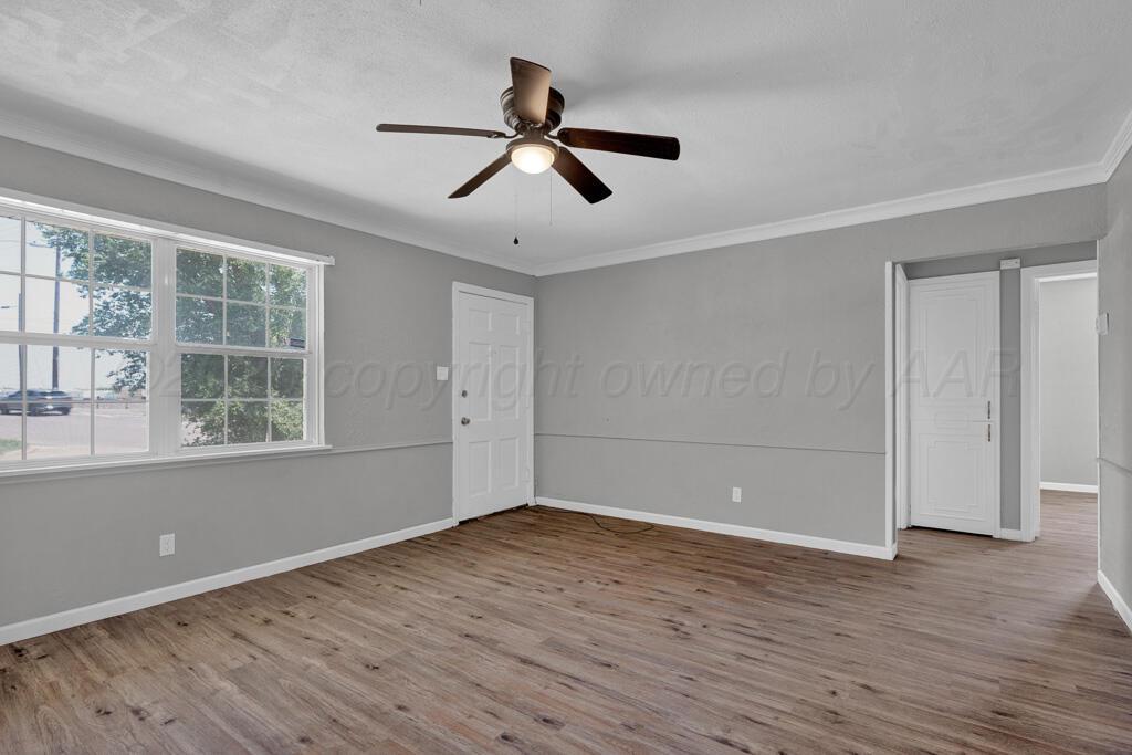 4360 South Polk Street Amarillo, TX 79110 - Photo 6 of 20 wooden floor in an empty room with a window