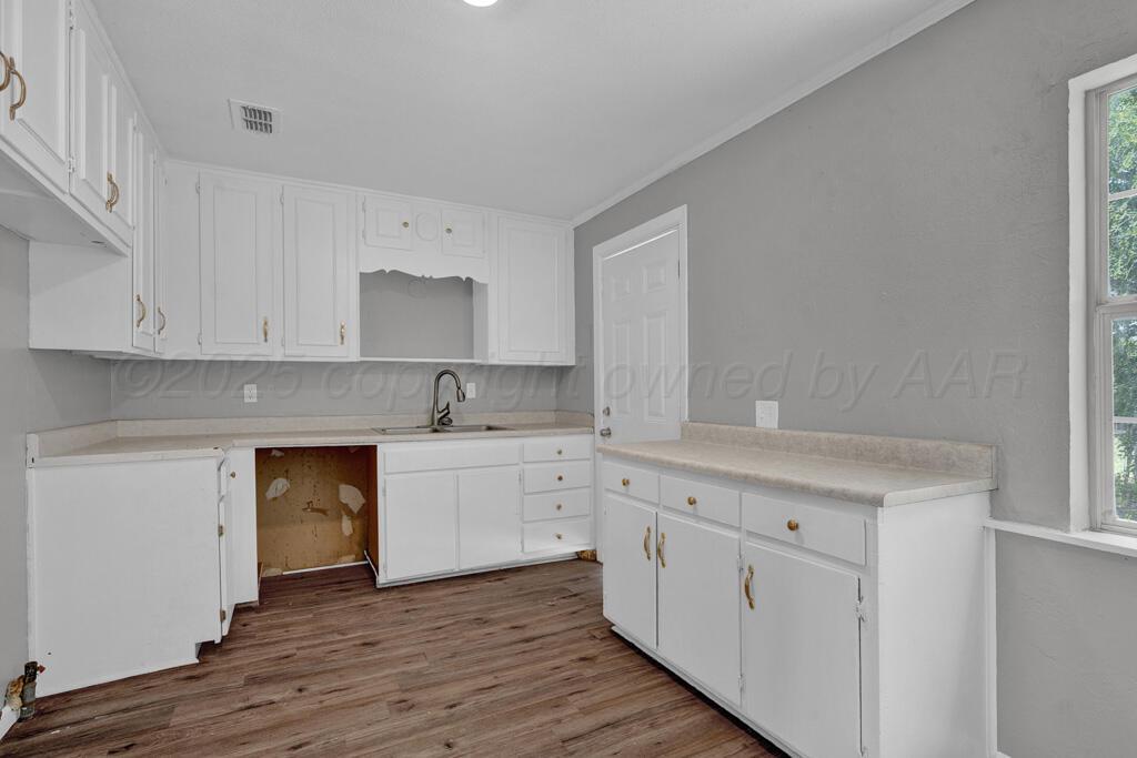 4360 South Polk Street Amarillo, TX 79110 - Photo 7 of 20 a kitchen with white cabinets and a stove