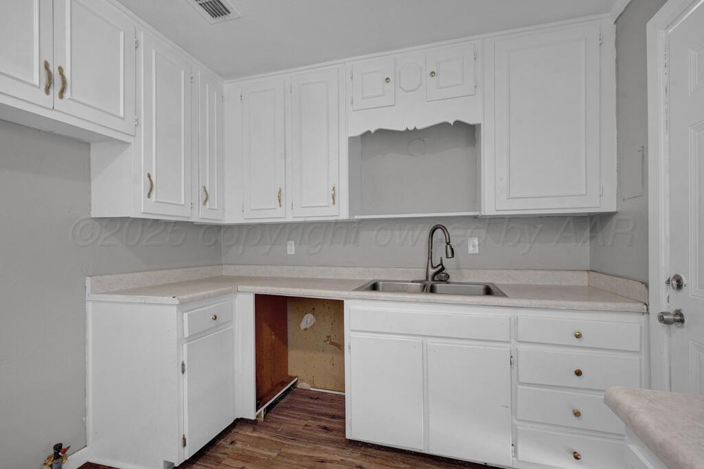 4360 South Polk Street Amarillo, TX 79110 - Photo 8 of 20 a kitchen with white cabinets and a sink