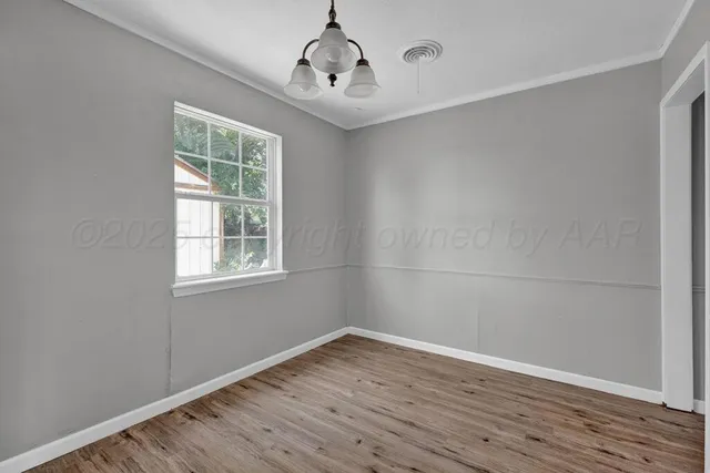 a view of a kitchen with wooden floor and a ceiling fan