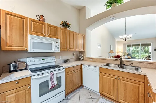a kitchen with a sink cabinets and window
