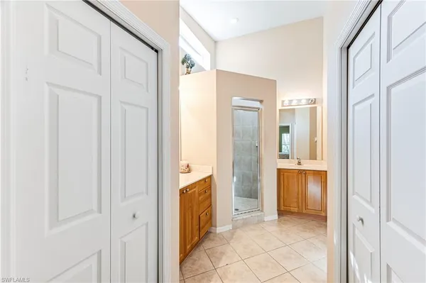 a bathroom with a glass door shower and a sink