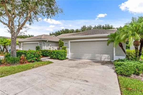 a front view of a house with a yard and a garage
