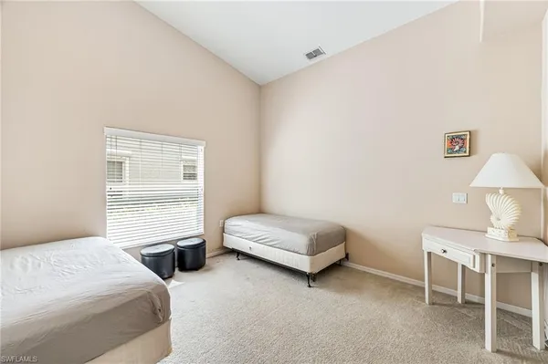 a bedroom with a bed and a chair