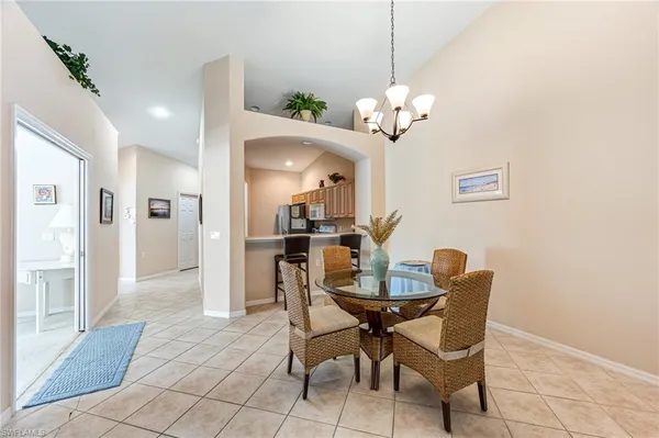 a view of a dining room with furniture and a chandelier