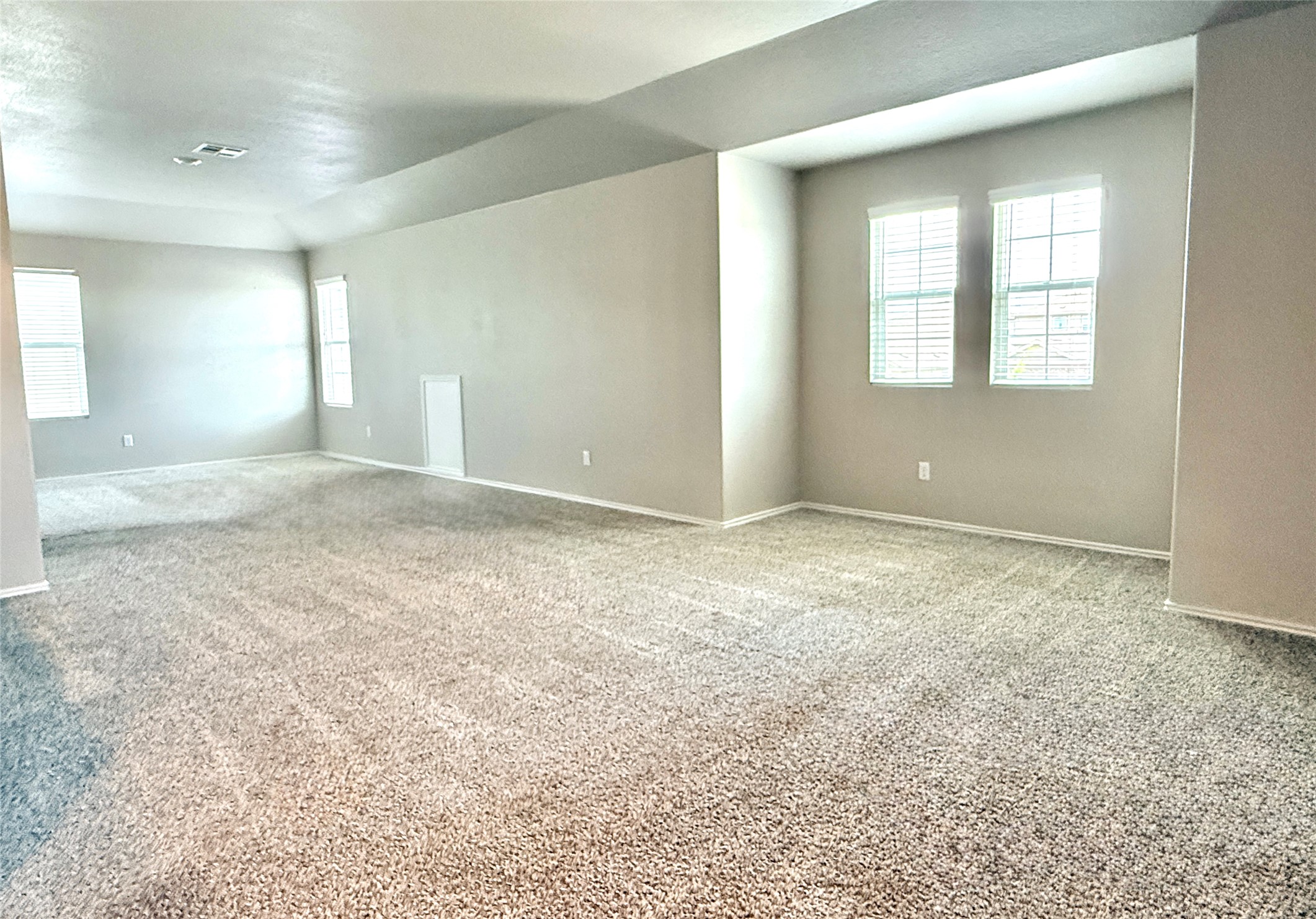 129 Perfect World Loop Jarrell, TX 76537 - Photo 21 of 31 A spacious room offers comfortable carpeting, ready for personalized living.