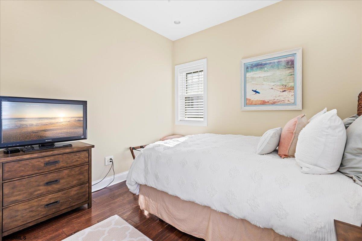 16 South Decatur Avenue, Unit 9/1510/31 Margate City, NJ 08402 - Photo 24 of 37 a bedroom with a bed and a flat screen tv