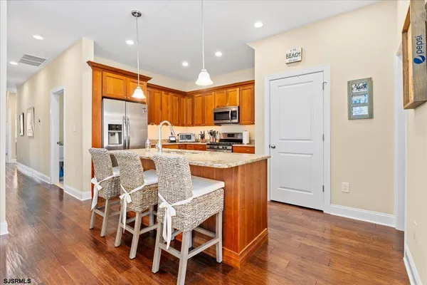 a view of a dining room with furniture and wooden floor