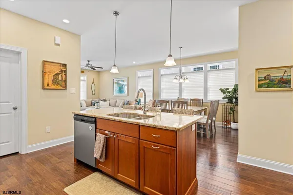 a kitchen with counter top space and wooden floor