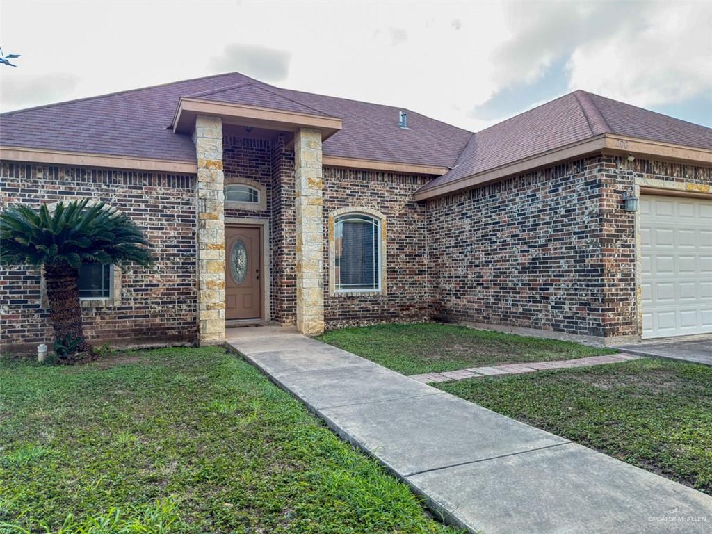 208 North 15th Street Hidalgo, TX 78557 - Photo 1 of 26 a front view of a house with a garden