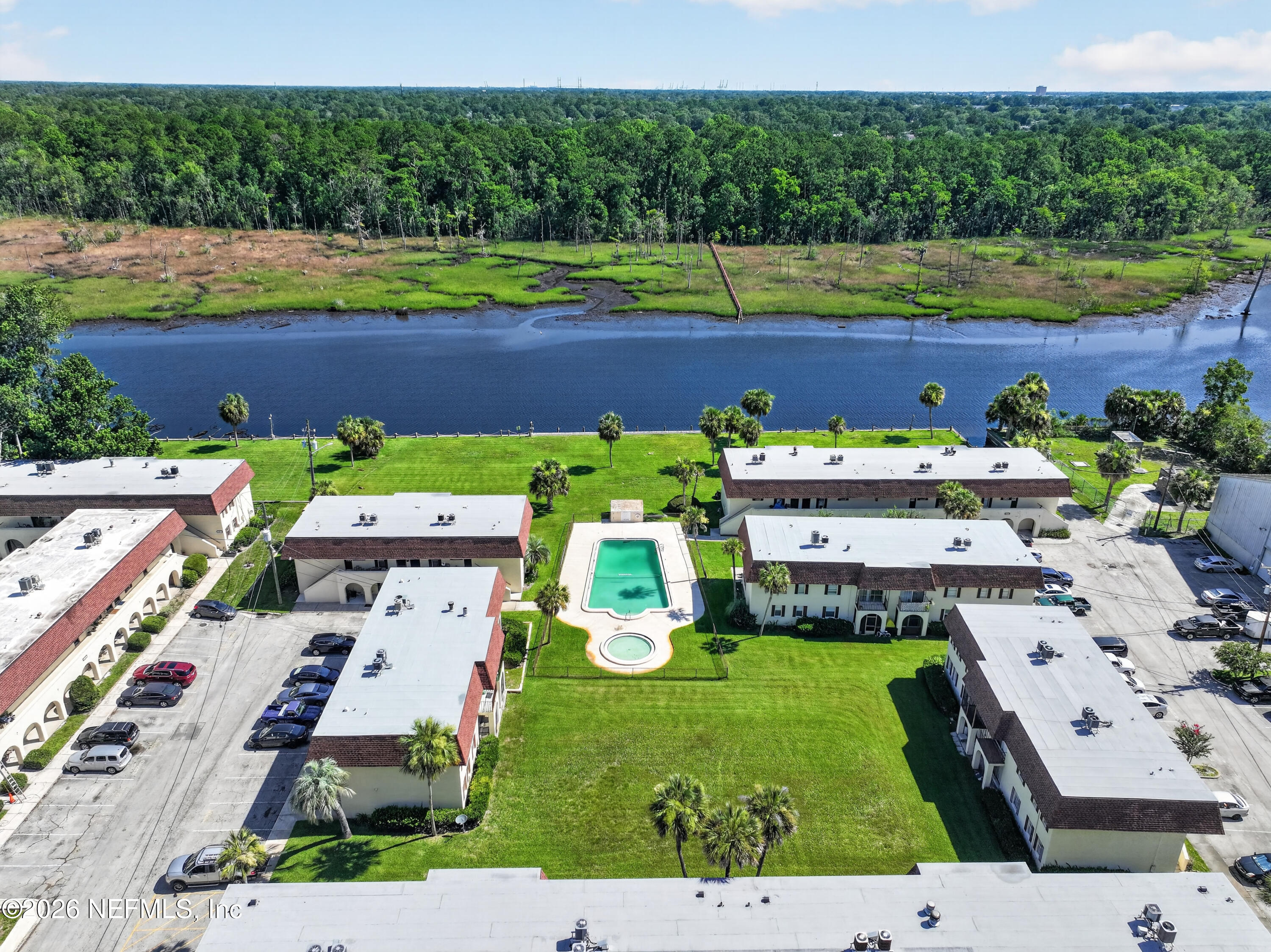 7346 El Barco Road, Unit 4 Jacksonville, FL 32216 - Photo 18 of 19 an aerial view of a house with a yard swimming pool outdoor seating and yard