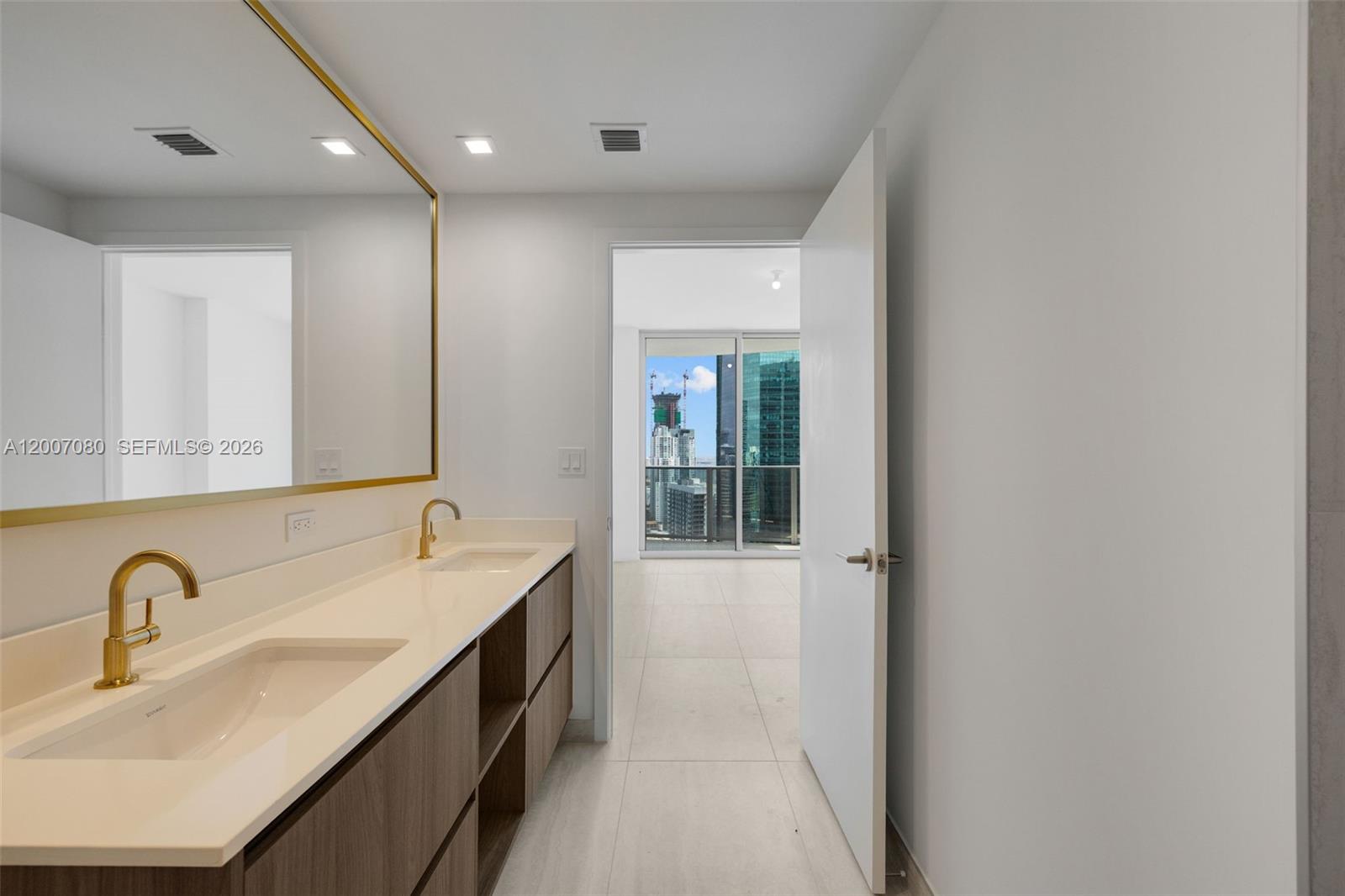 77 Southeast 5th Street, Unit PH01 Miami, FL 33131 - Photo 23 of 31 a bathroom with a double vanity sink and mirror
