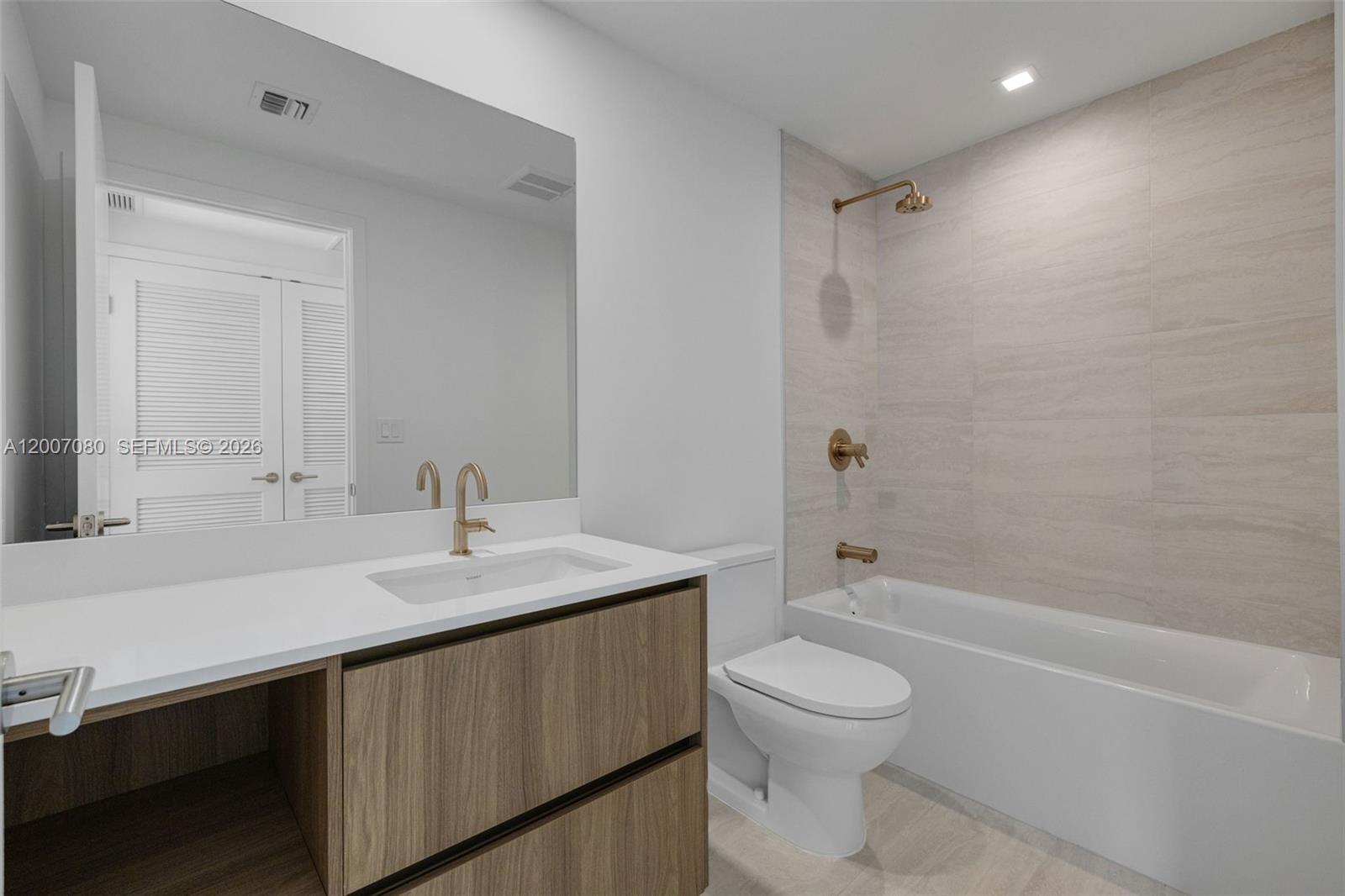 77 Southeast 5th Street, Unit PH01 Miami, FL 33131 - Photo 27 of 31 a bathroom with a sink a toilet and shower