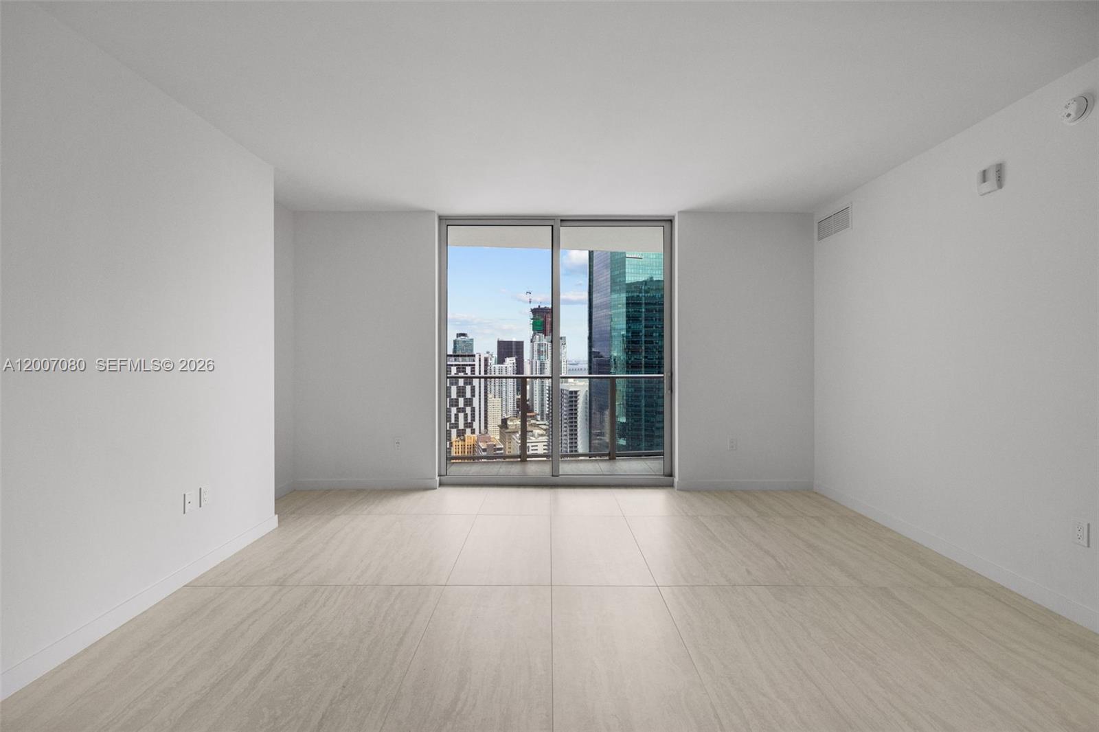 77 Southeast 5th Street, Unit PH01 Miami, FL 33131 - Photo 29 of 31 wooden floor in an empty room with a glass door