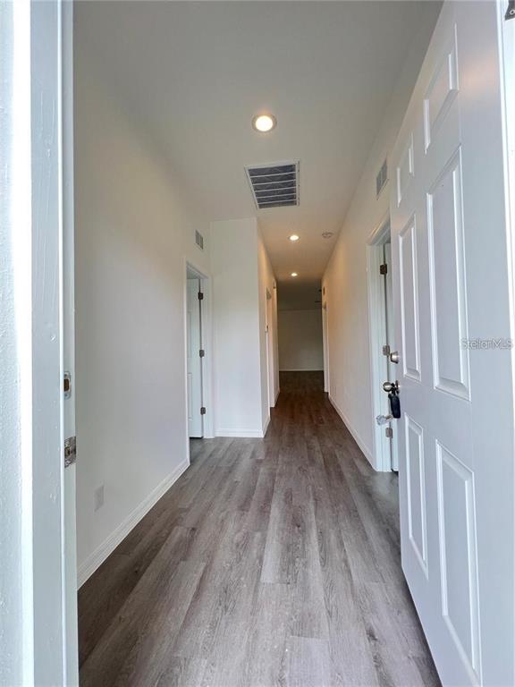 273 Santa Martia Street Southwest Palm Bay, FL 32908 - Photo 2 of 12 a view of a hallway with wooden floor