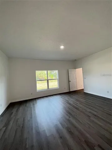a view of room and wooden floor and window in a room